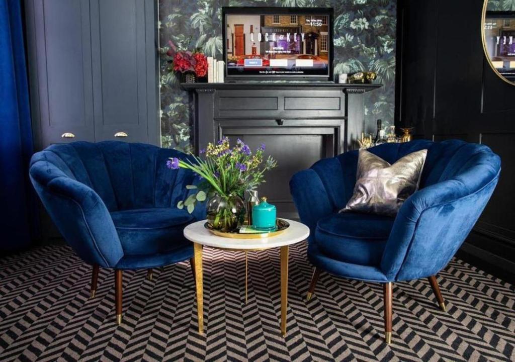 two blue chairs and a table in a room at Lock and Key Boutique Hotel - Duke Street in Liverpool