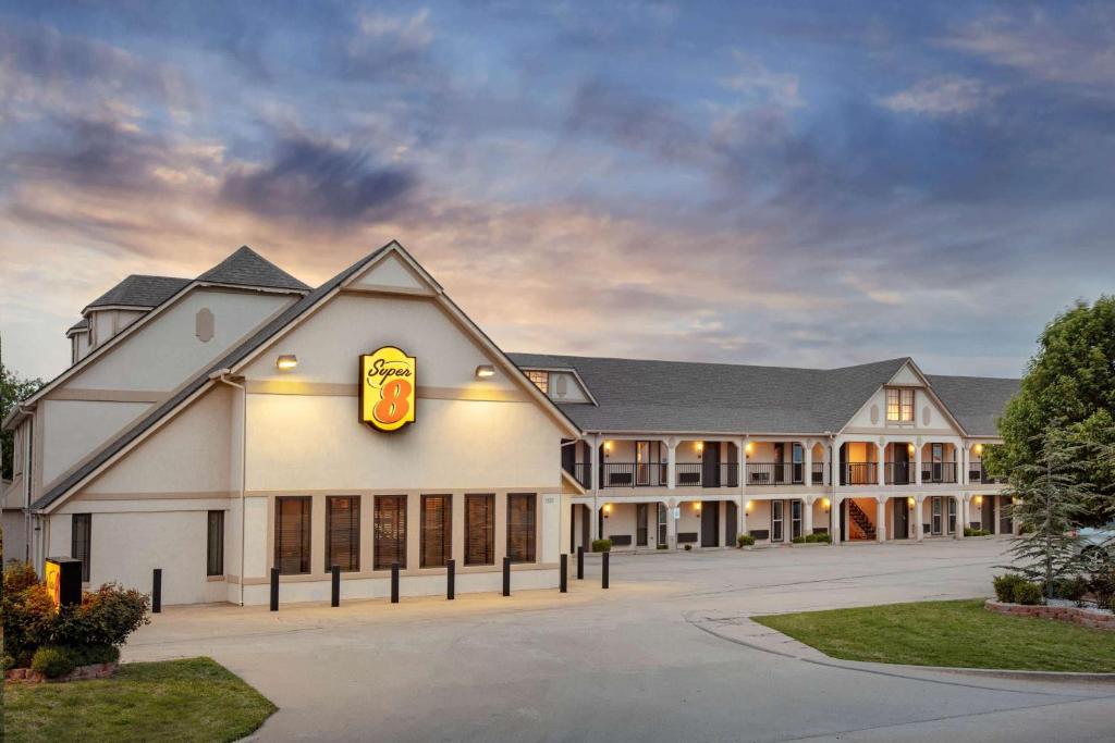 un grande edificio bianco con un cartello McDonalds di Super 8 by Wyndham City of Moore a Moore