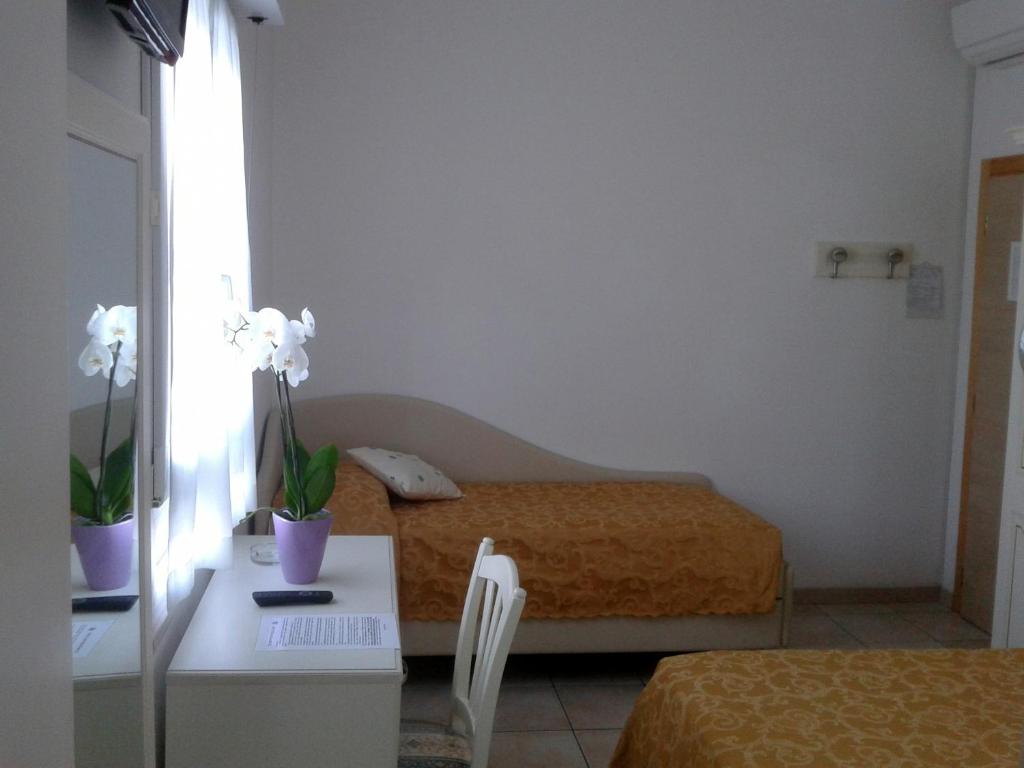 Postel nebo postele na pokoji v ubytování Albergo Villa Aida