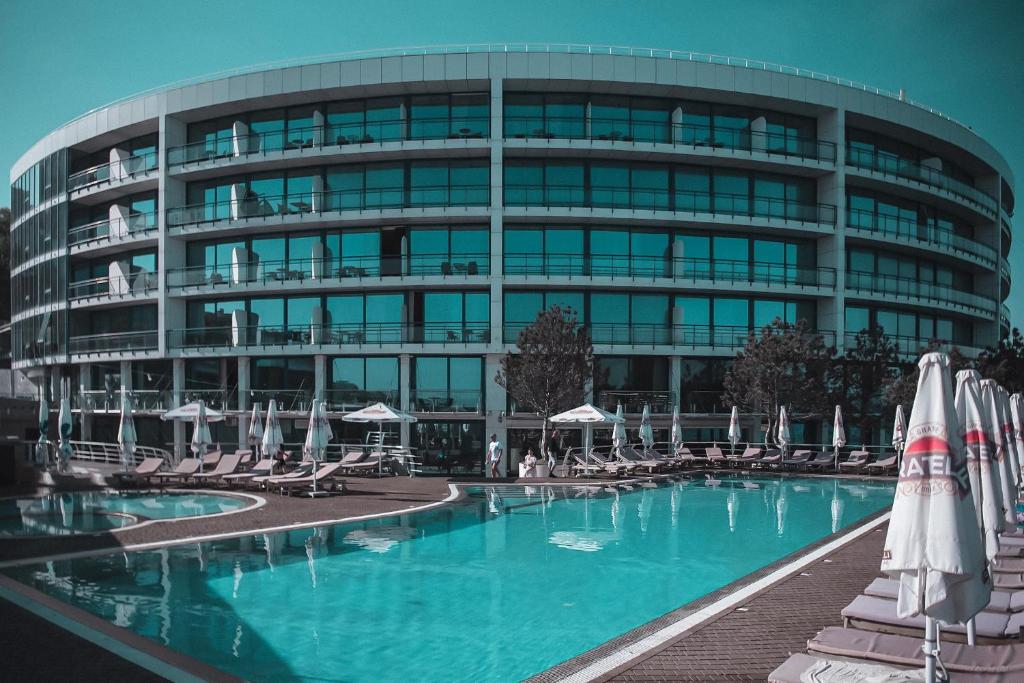a large building with a swimming pool in front of it at Marine Residence in Odesa