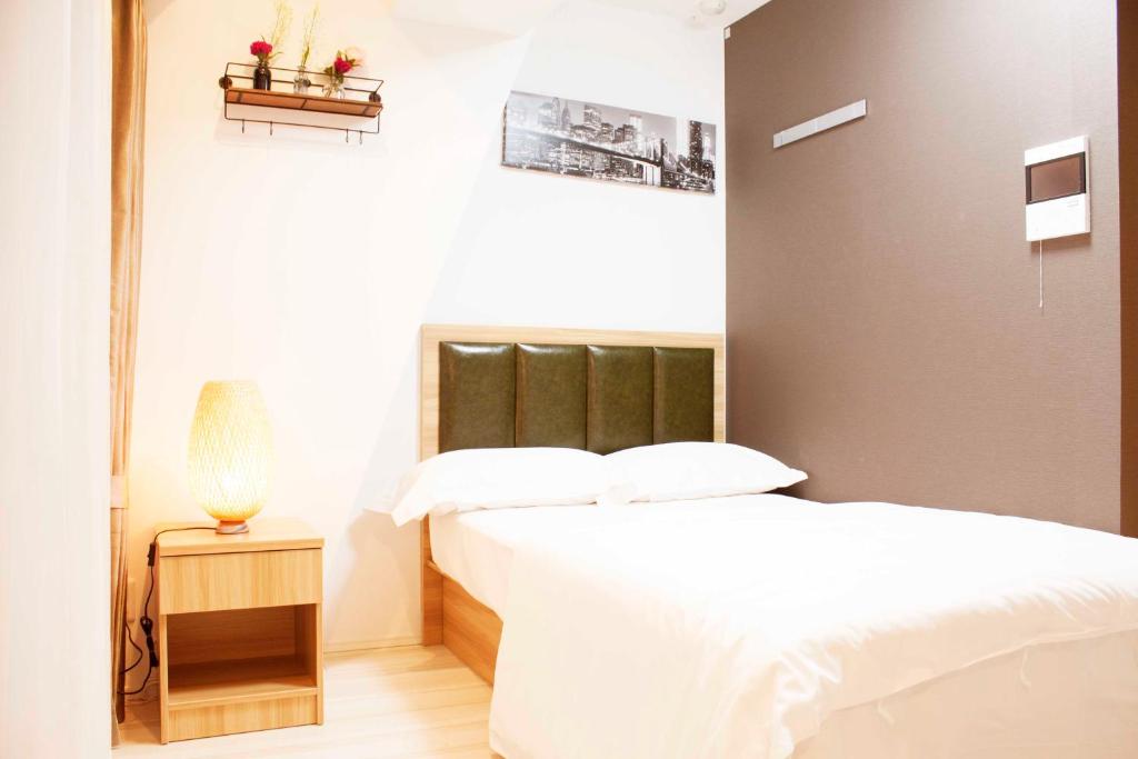 Postel nebo postele na pokoji v ubytování Hotel Shu
