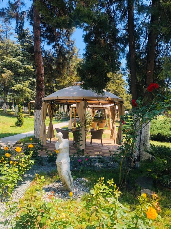 a gazebo with a statue in a garden at Hotel Corina in Venus