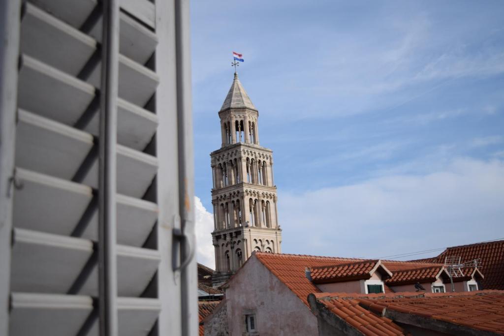 a building with a clock on the top of it at Old Town Hostel Split in Split