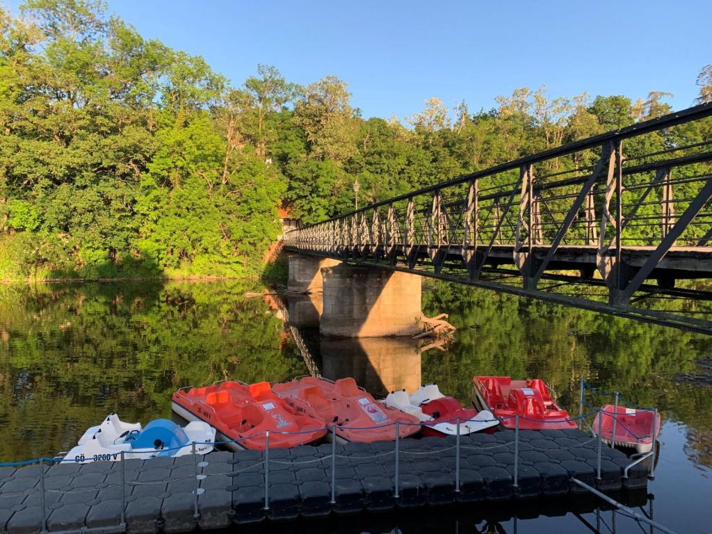 a group of boats sitting in the water next to a bridge at &quot;An der Lindenberganlage&quot; in Melsungen