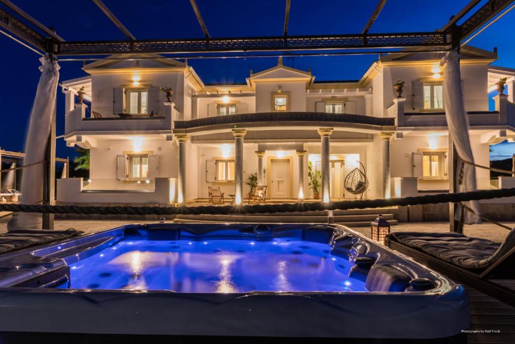 a large house with a hot tub in front of it at Τhalasso Palace Homes in Petrití