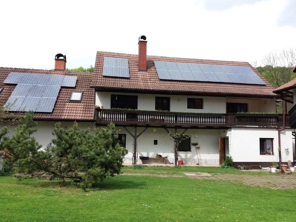 a house with solar panels on the roof at U tří jasanů in Luže