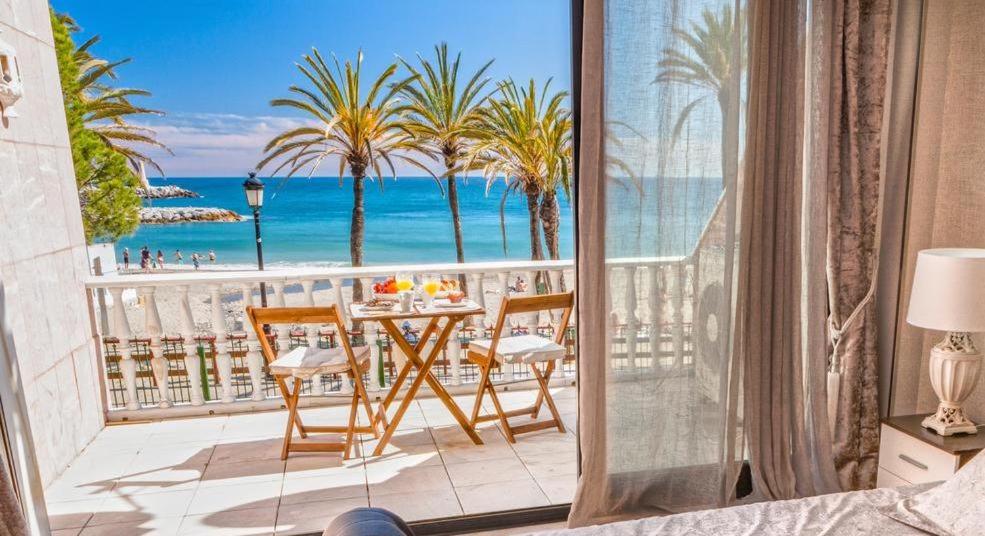 a balcony with a table with a view of the ocean at Puerto Banús Beach Apartments in Marbella