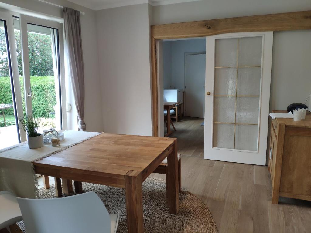 a living room with a wooden table and a dining room at HAuszeit - Zeit für dich - Zeit am See in Neufeld an der Leitha