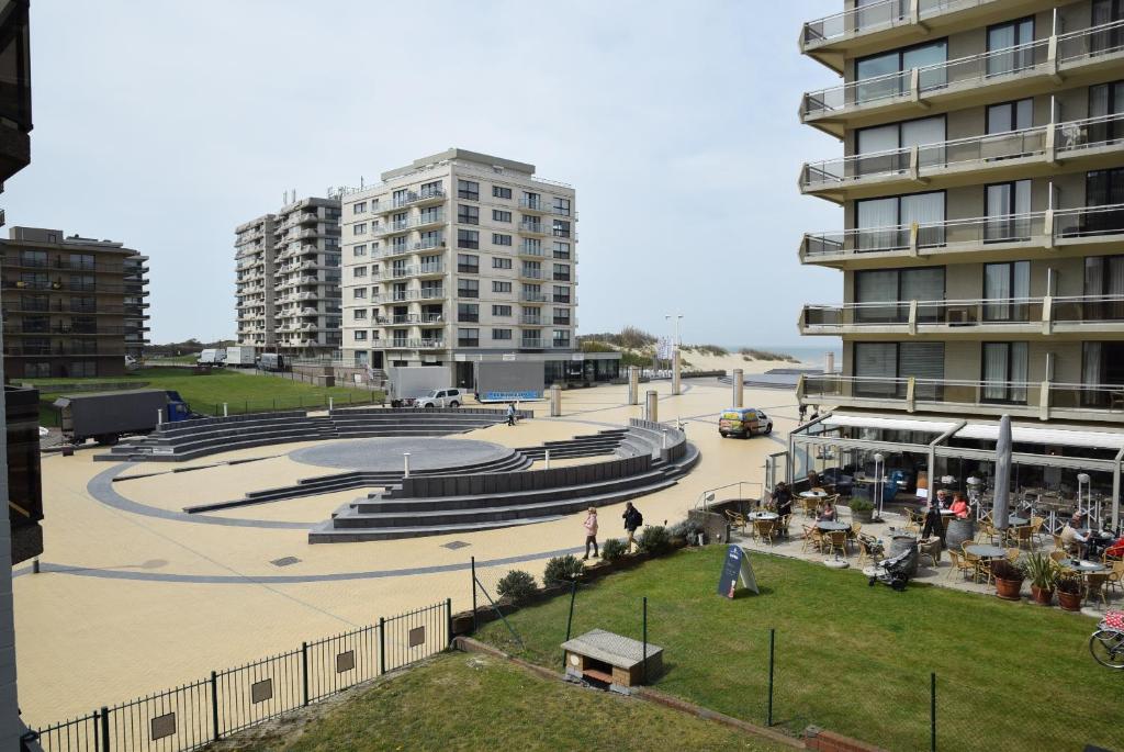 a large amphitheater in a city with tall buildings at Bella Plaza in De Panne