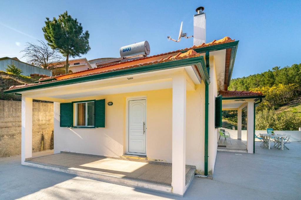 a small white house with a roof at Casa da Oliveira, Aradas, Pampilhosa da Serra, Wifi, Ar Condicionado, Churrasqueira, Parqueamento, by IG in Unhais-o-Velho