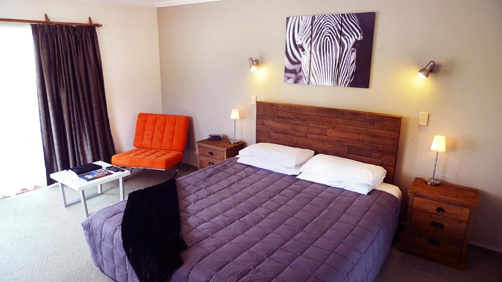 Postel nebo postele na pokoji v ubytování Rotorua Coachman Spa Motel
