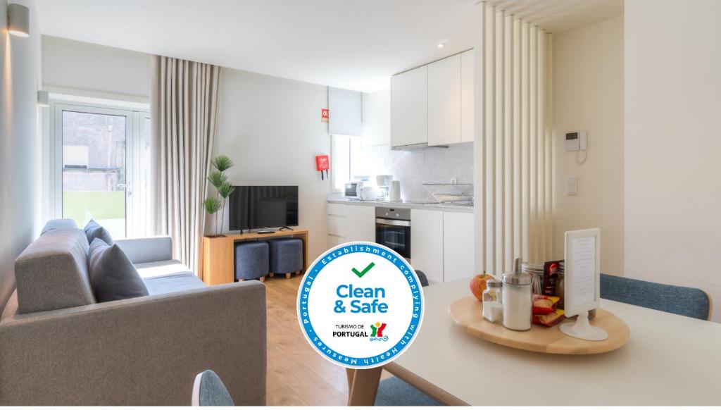 a kitchen and a living room with a sign on a table at Spot Family Apartments in Porto