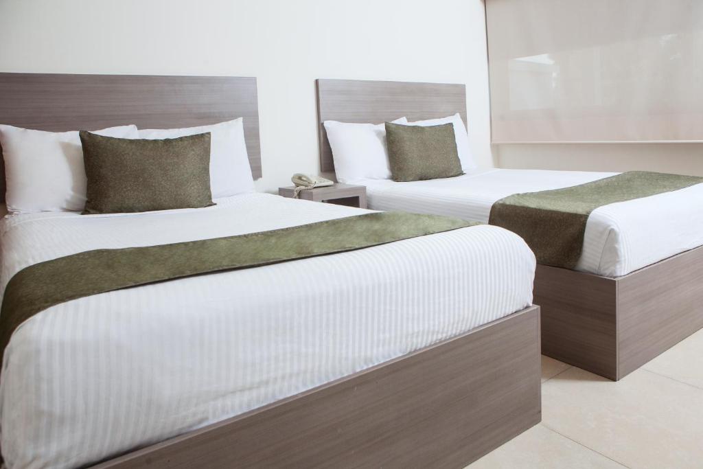 Säng eller sängar i ett rum på Hotel La Riviera