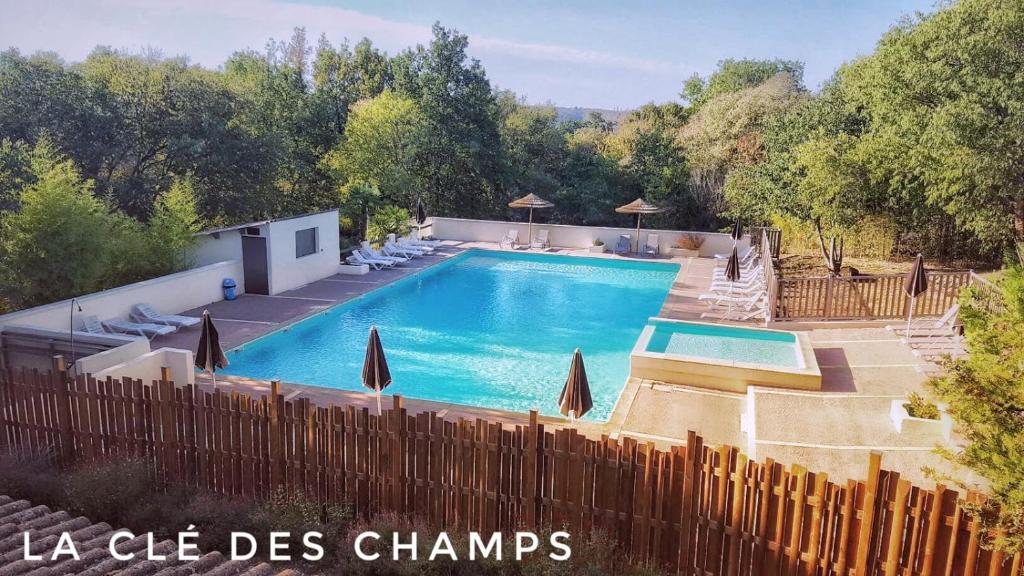 a swimming pool in a yard with a wooden fence at La Cle Des Champs in Montréal