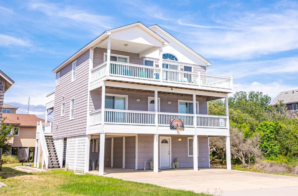 a large white house with a balcony at Ocean View's in Kill Devil Hills