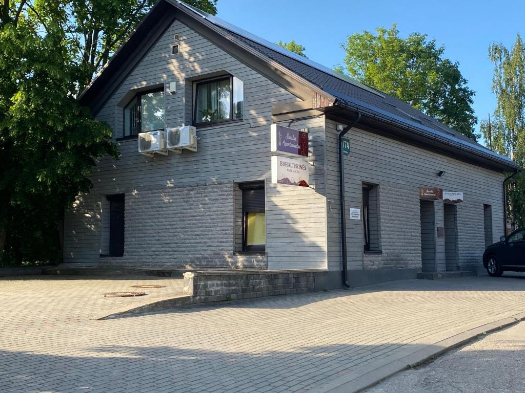 a building with a car parked in front of it at Šiauliu apartamentai in Šiauliai