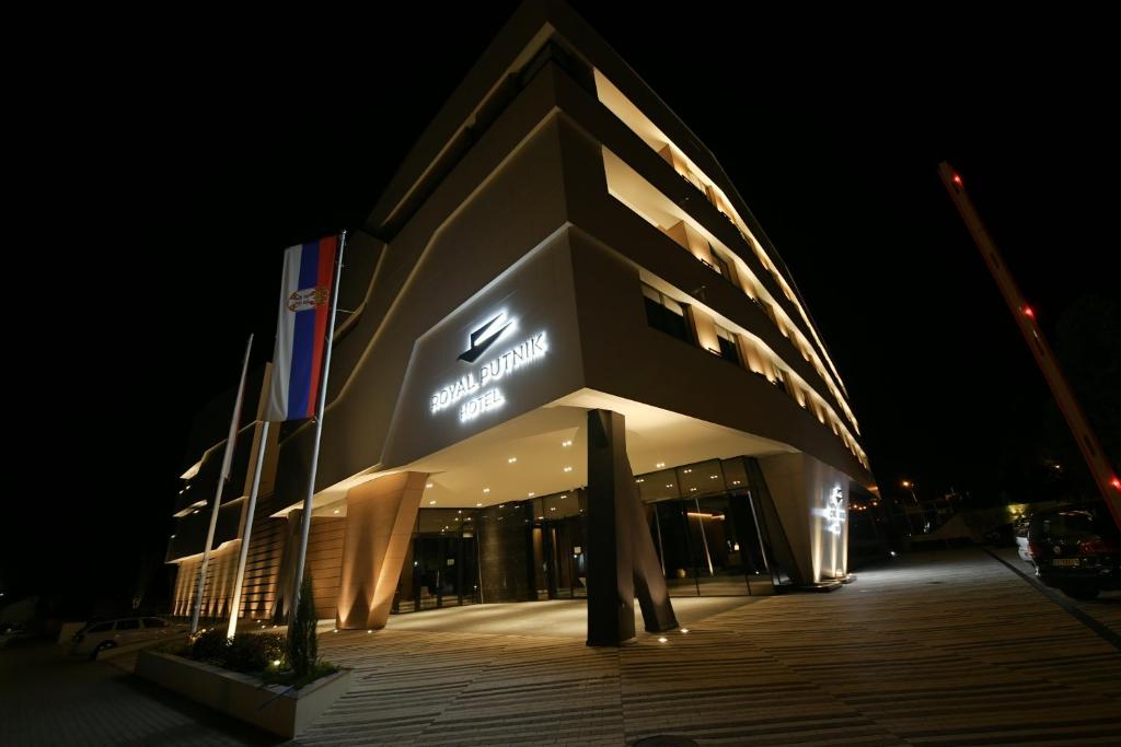 a building with a sign on it at night at Hotel Royal Putnik in Vranje