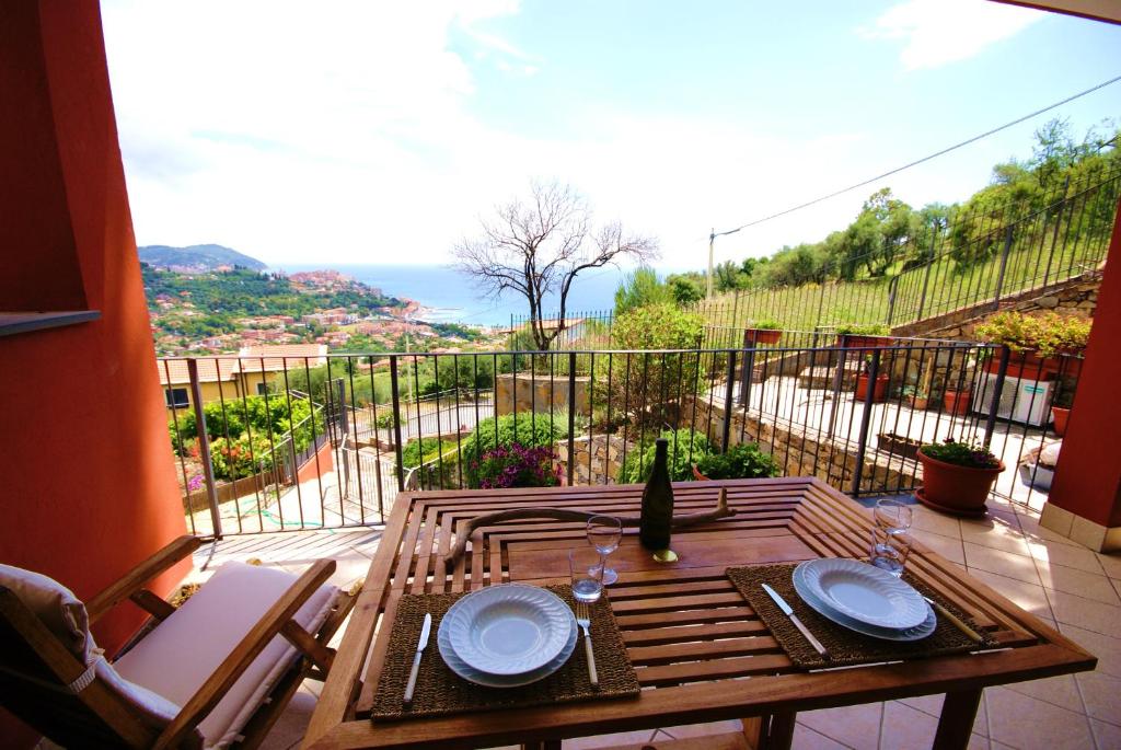 a table on a balcony with a view of the ocean at LOFT BAYVIEW in Imperia