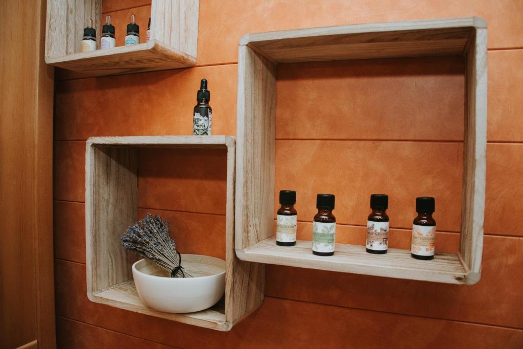 a room with bottles of whiskey on shelves at Apartma Metija LUX z savno in Kobarid