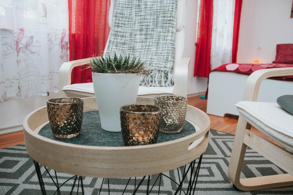 a table with four potted plants on it in a room at Apartma Metija LUX z savno in Kobarid