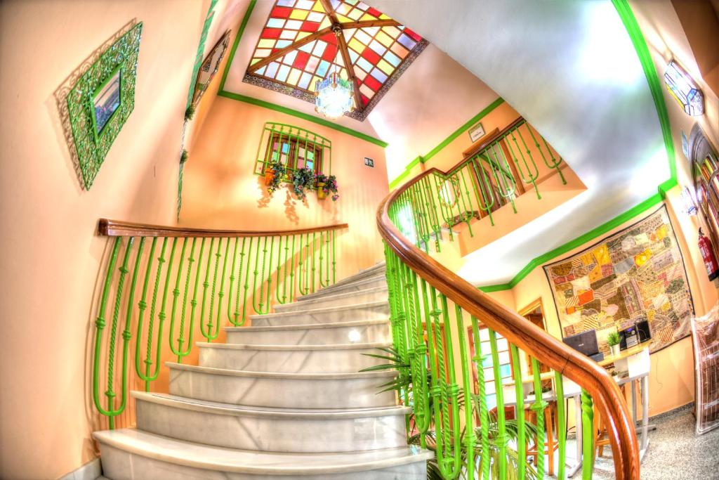 a spiral staircase in a building with plants at Charming Nerja Hostel in Nerja
