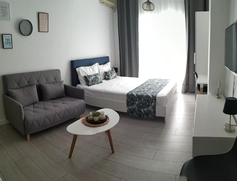 a small living room with a bed and a couch at stuDio57 11 in Alexandroupoli