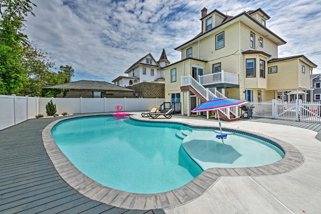 a swimming pool in front of a large house at Seaside Wildwood Haven Walk to Boardwalk and Beach! in Wildwood Crest