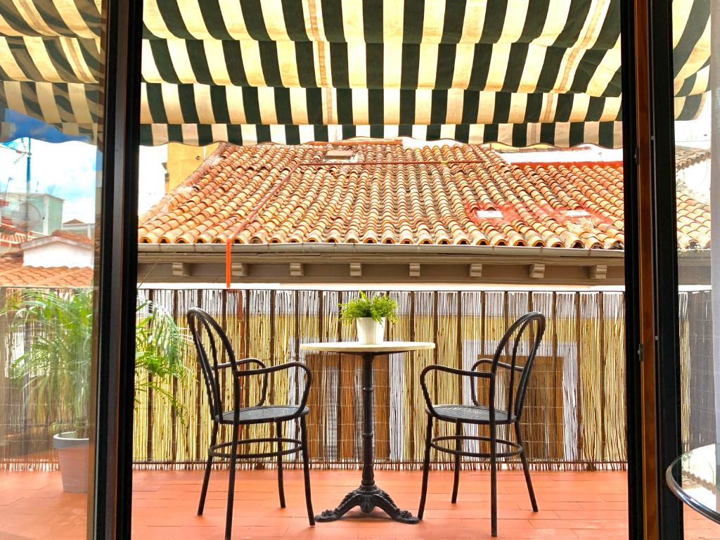 two chairs and a table on a patio at Apartamentos Puerta Del Sol in Madrid