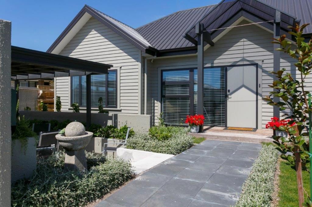 a house with a pathway leading to the front door at Stay Taupo in Taupo