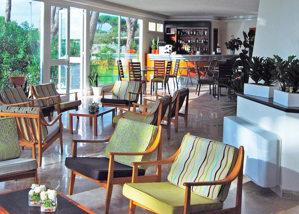 a restaurant with a bunch of chairs and a bar at Torre Del Sole in Terracina