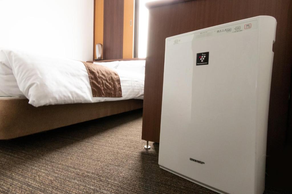 Postel nebo postele na pokoji v ubytování Toyo Hotel