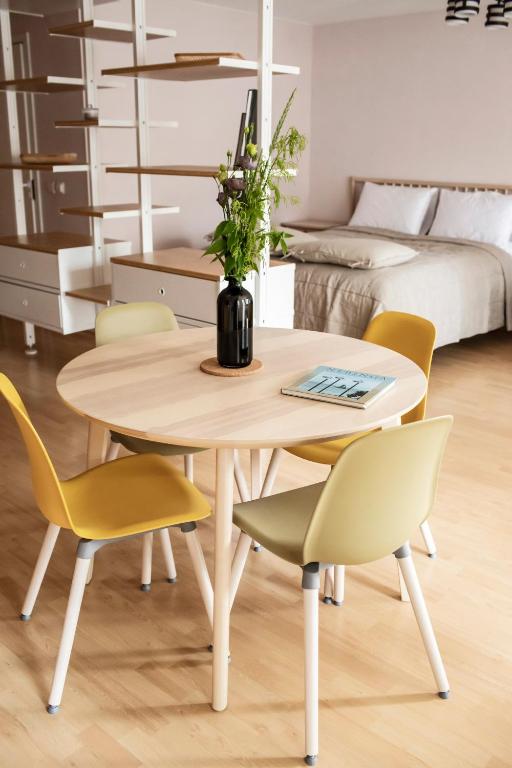 a table and chairs in a room with a bed at NIDA in Nida
