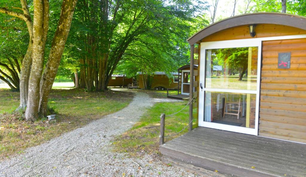 a small wooden cabin with a door and a porch at Logis Domaine du Seudre in Saint-Germain-du-Seudre
