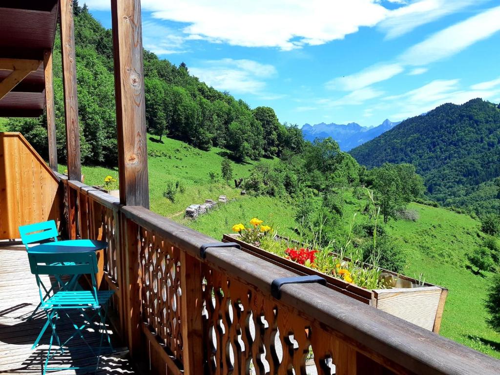 a balcony with chairs and a view of a valley at Les Chemins du Léman in Novel
