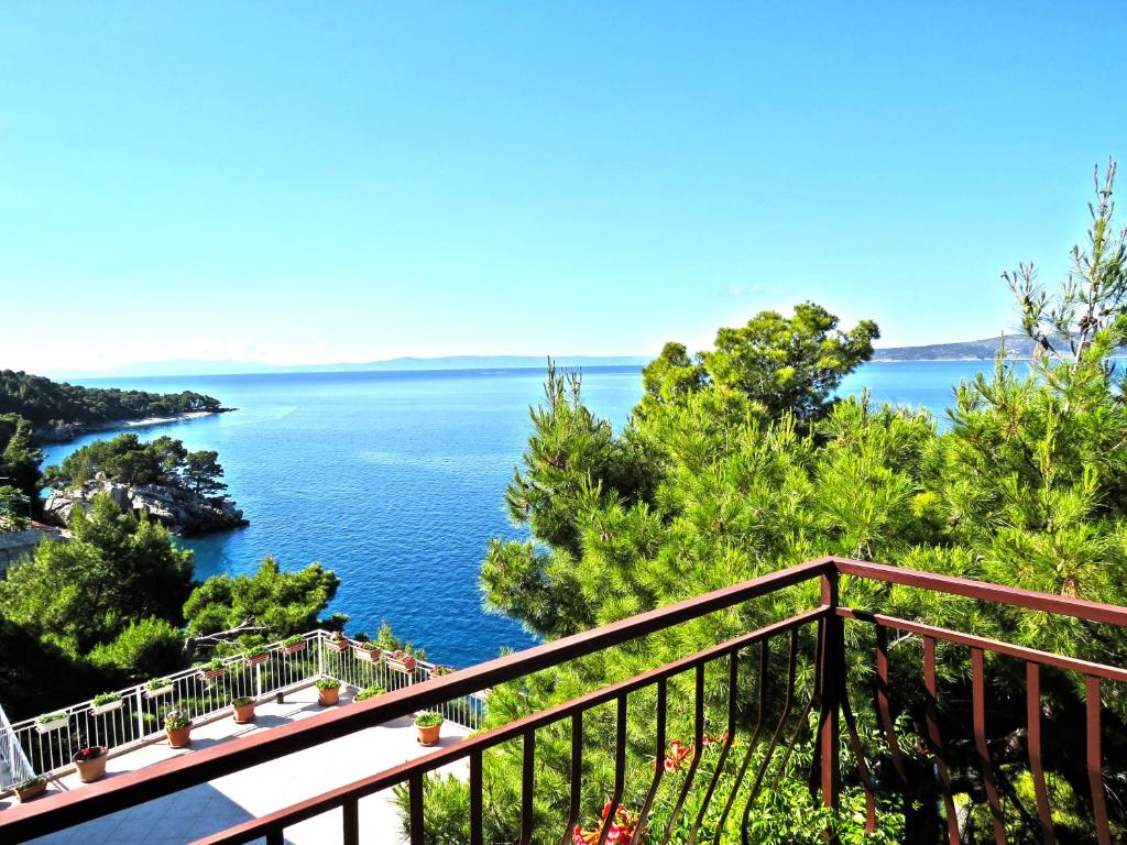 a view of the water from a balcony at Apartments Pino Brela in Brela