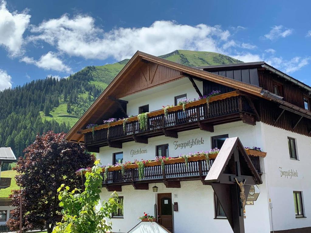 a building with a balcony on top of it at Gästehaus Zugspitzblick in Berwang