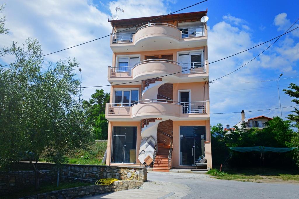 a large white building with balconies on top of it at Luxury Dream House in Limenaria