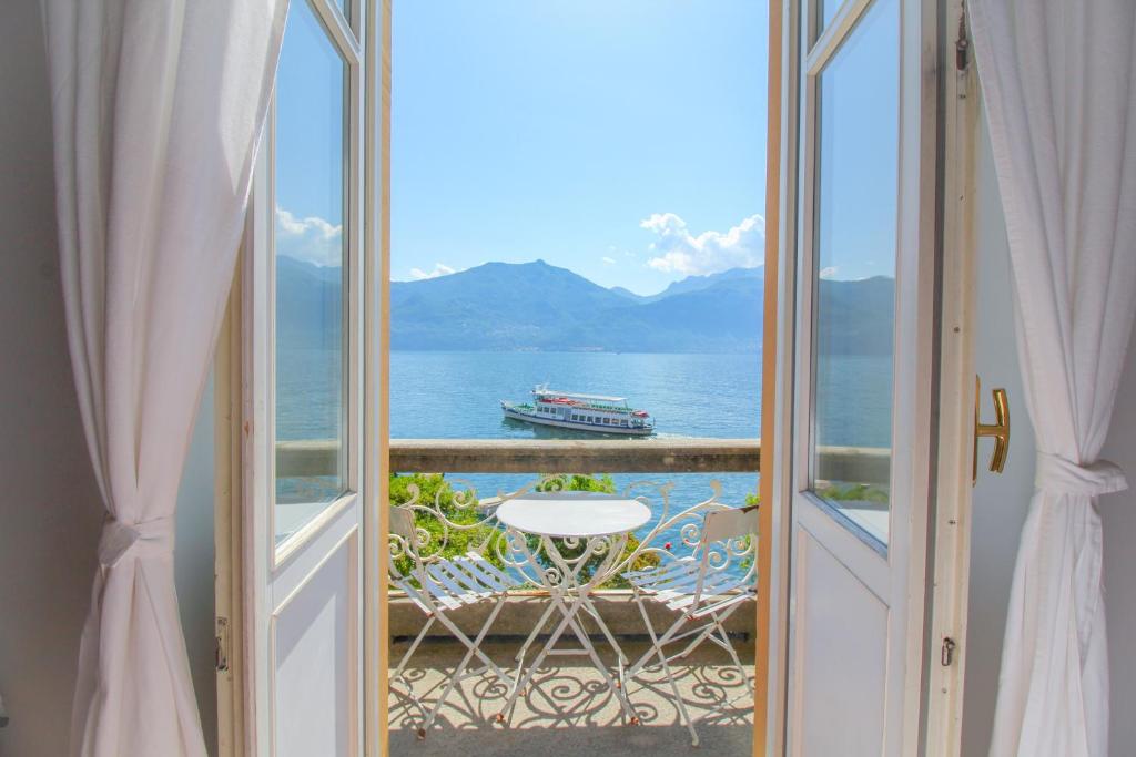 a balcony with a view of the ocean and a boat at Lario Elegante in Menaggio