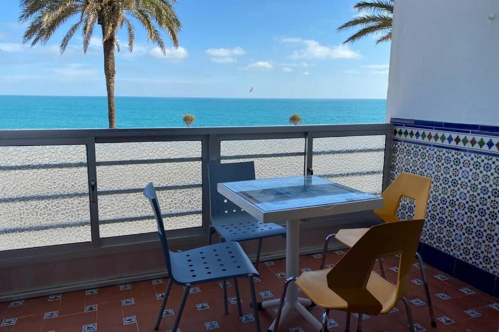 a table and chairs on a balcony with the beach at Mirador Playa Caleta Cádiz Centro Grupo AC Gestion in Cádiz