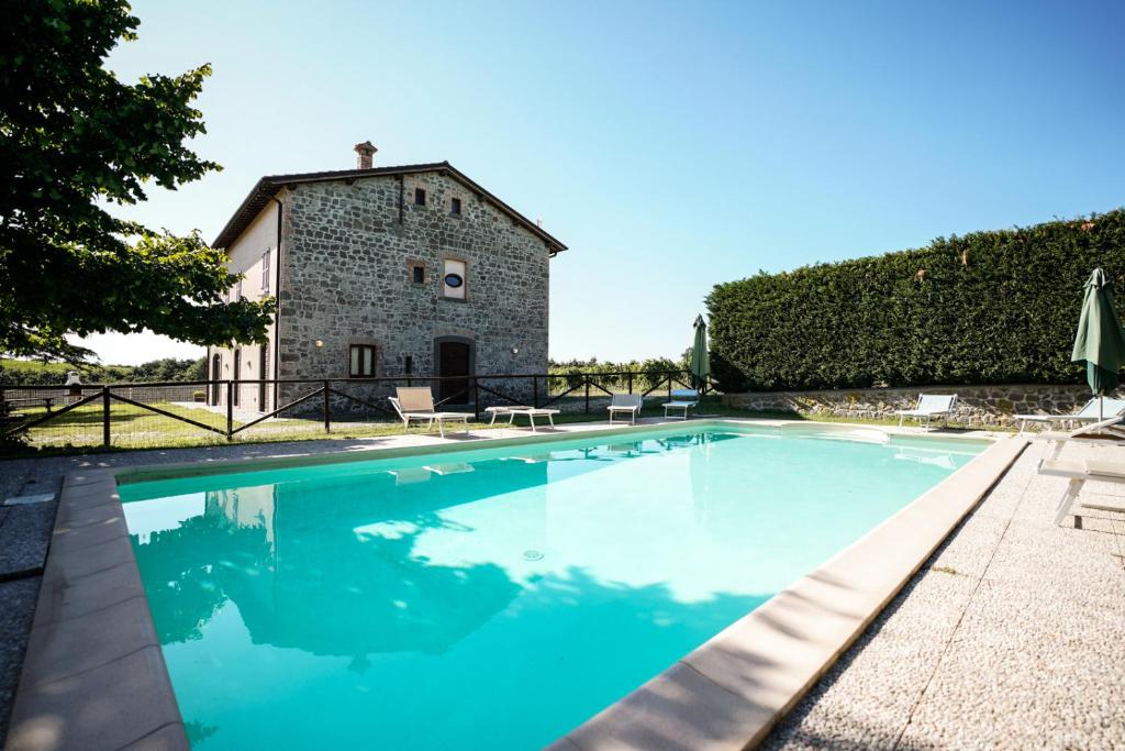 a large swimming pool in front of a building at Agriturismo Vigna Sul Lago in Montefiascone