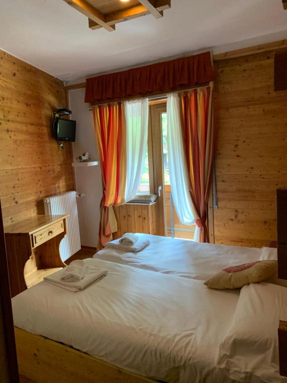 Postel nebo postele na pokoji v ubytování Hotel Capriolo
