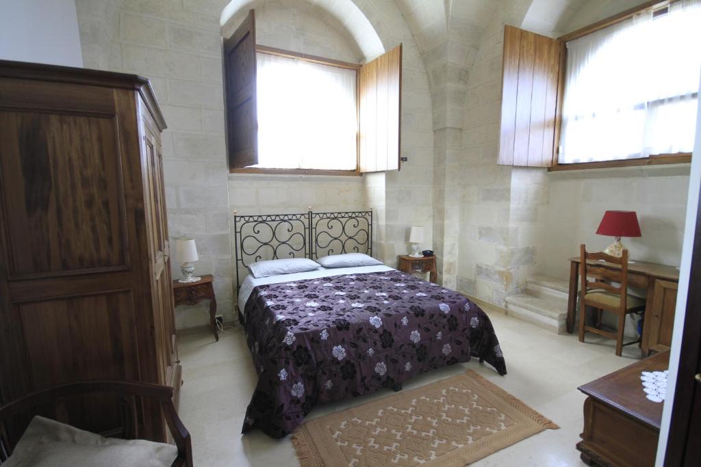 Кровать или кровати в номере Masseria Gattamora