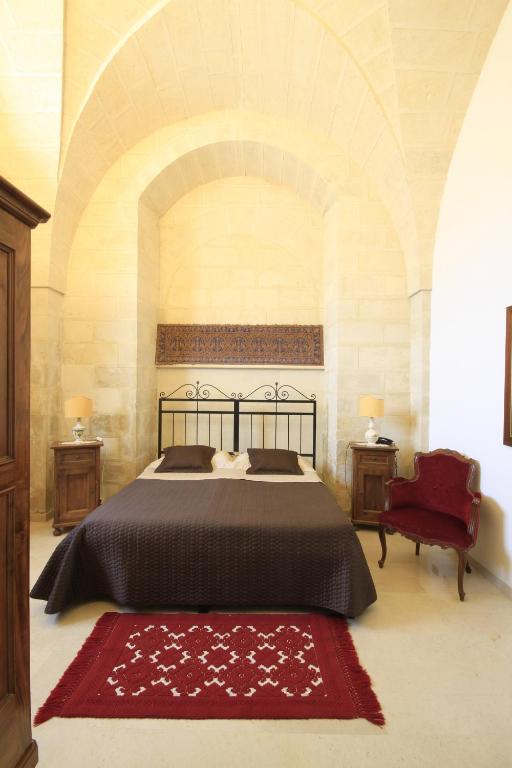 Кровать или кровати в номере Masseria Gattamora