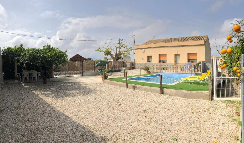 a house with a swimming pool in a yard at Casa Los Hortets in Deltebre