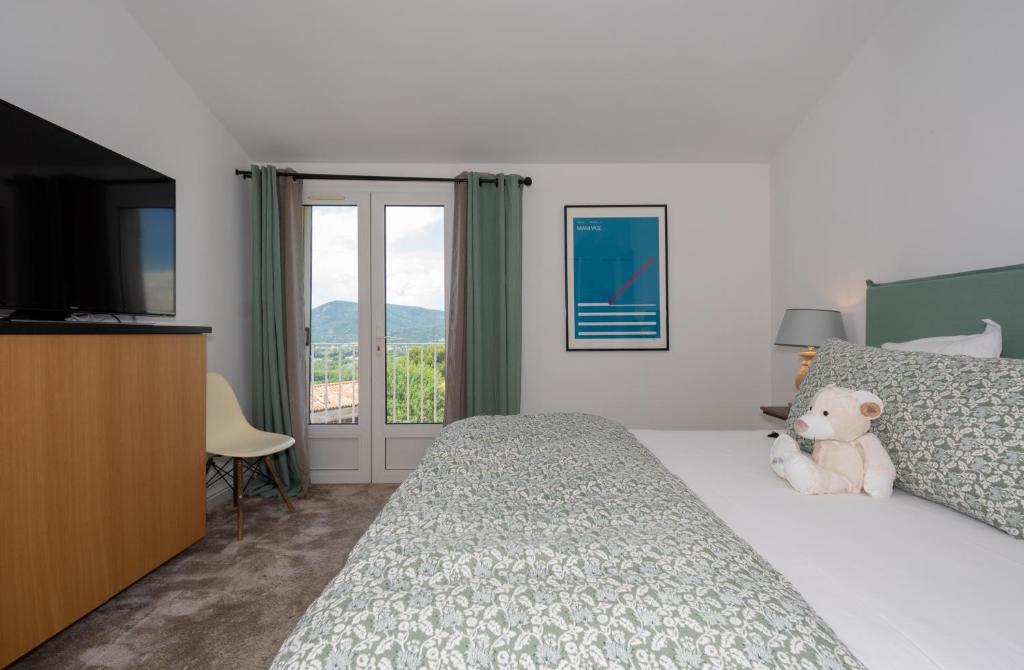 Postel nebo postele na pokoji v ubytování Hôtel Font Mourier