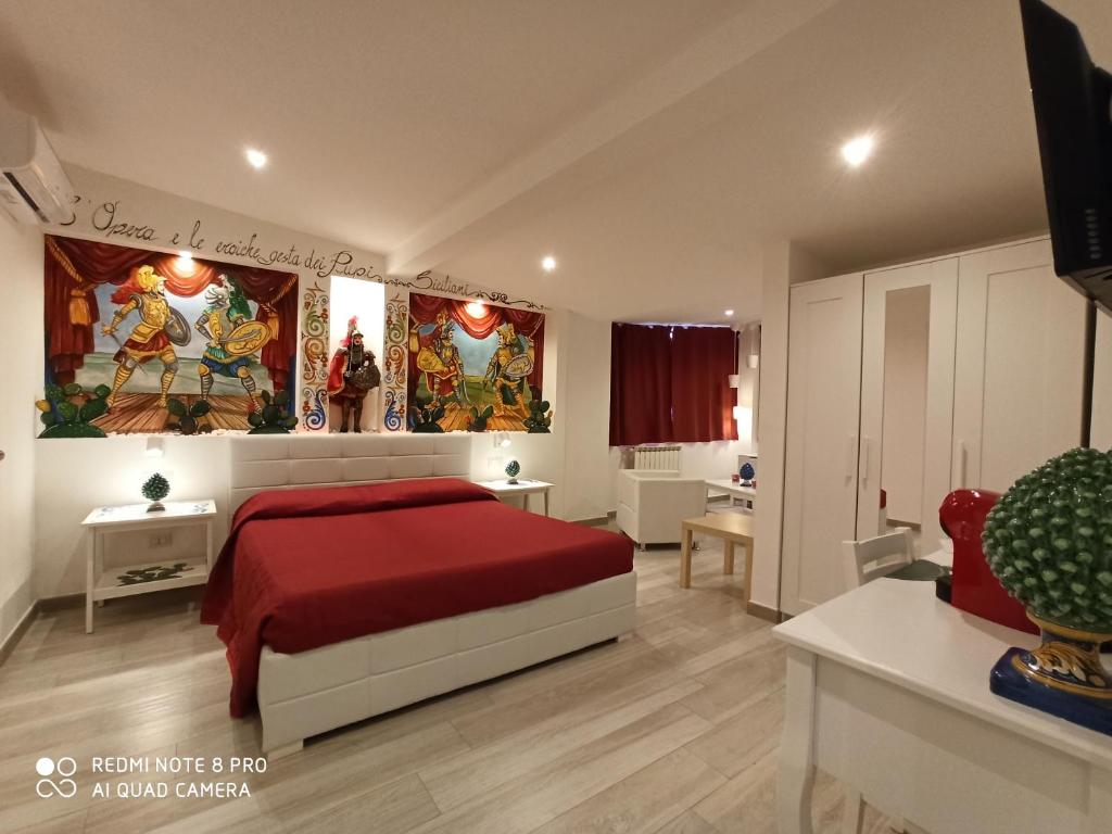 a bedroom with a large bed and a large window at B&B Triskèles in Giardini Naxos
