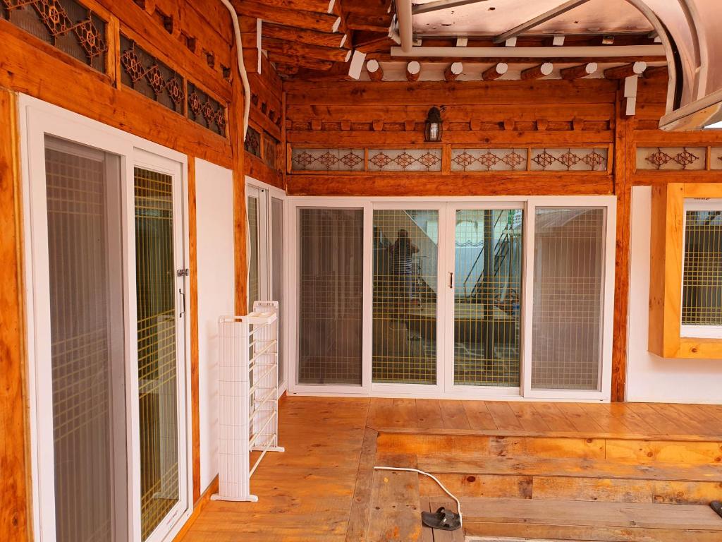 a screened in porch with sliding glass doors at Hwangridangil Adamjeong in Gyeongju