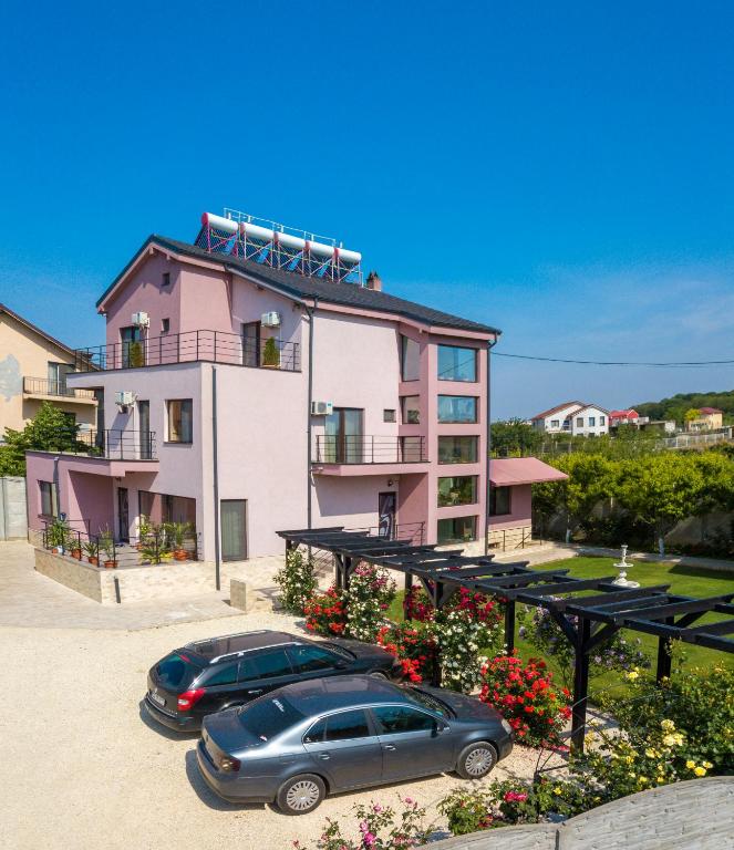 two cars parked in front of a building at Kys House in Techirghiol