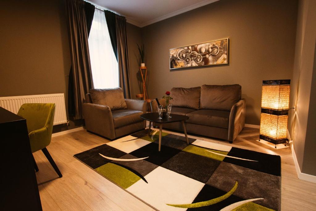 a living room with a couch and a table at Resita Residence Sauna Apartment in Reşiţa