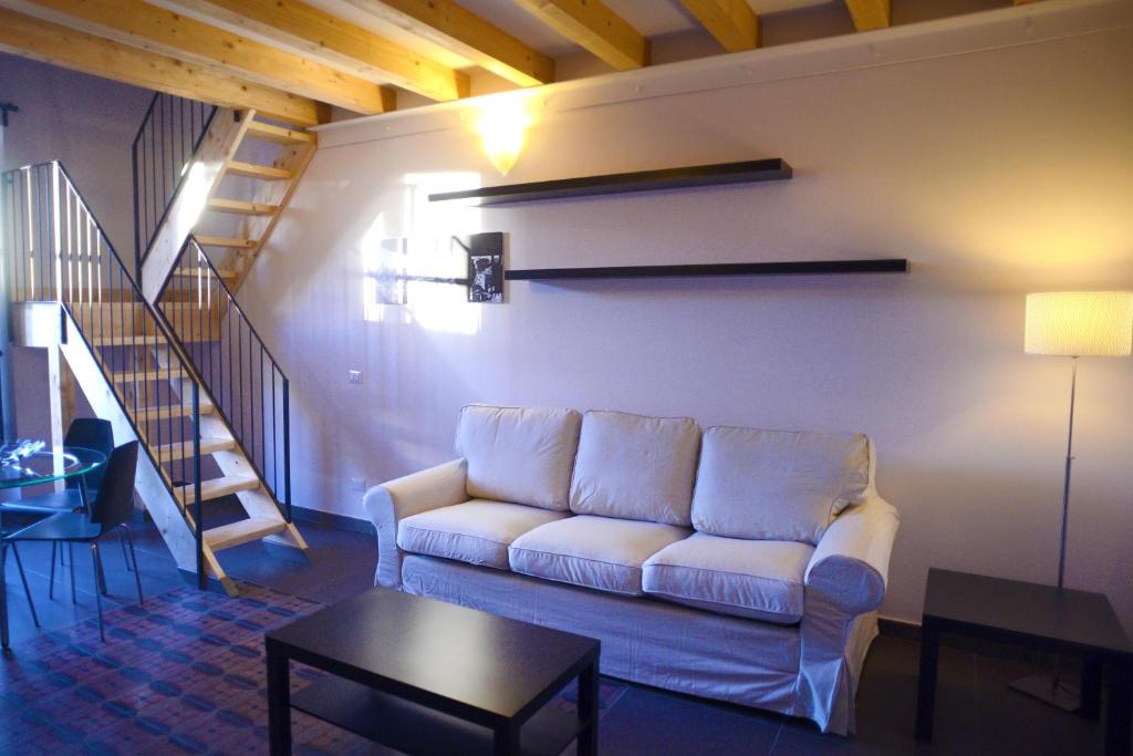 a living room with a couch and a staircase at B&B Thule in Caltanissetta